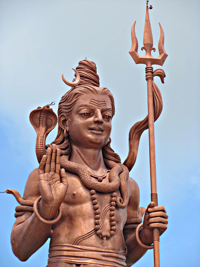 Close-up of the bronze Mangal Mahadev statue at Ganga Talao, Mauritius — raised palm, cobra and trishul