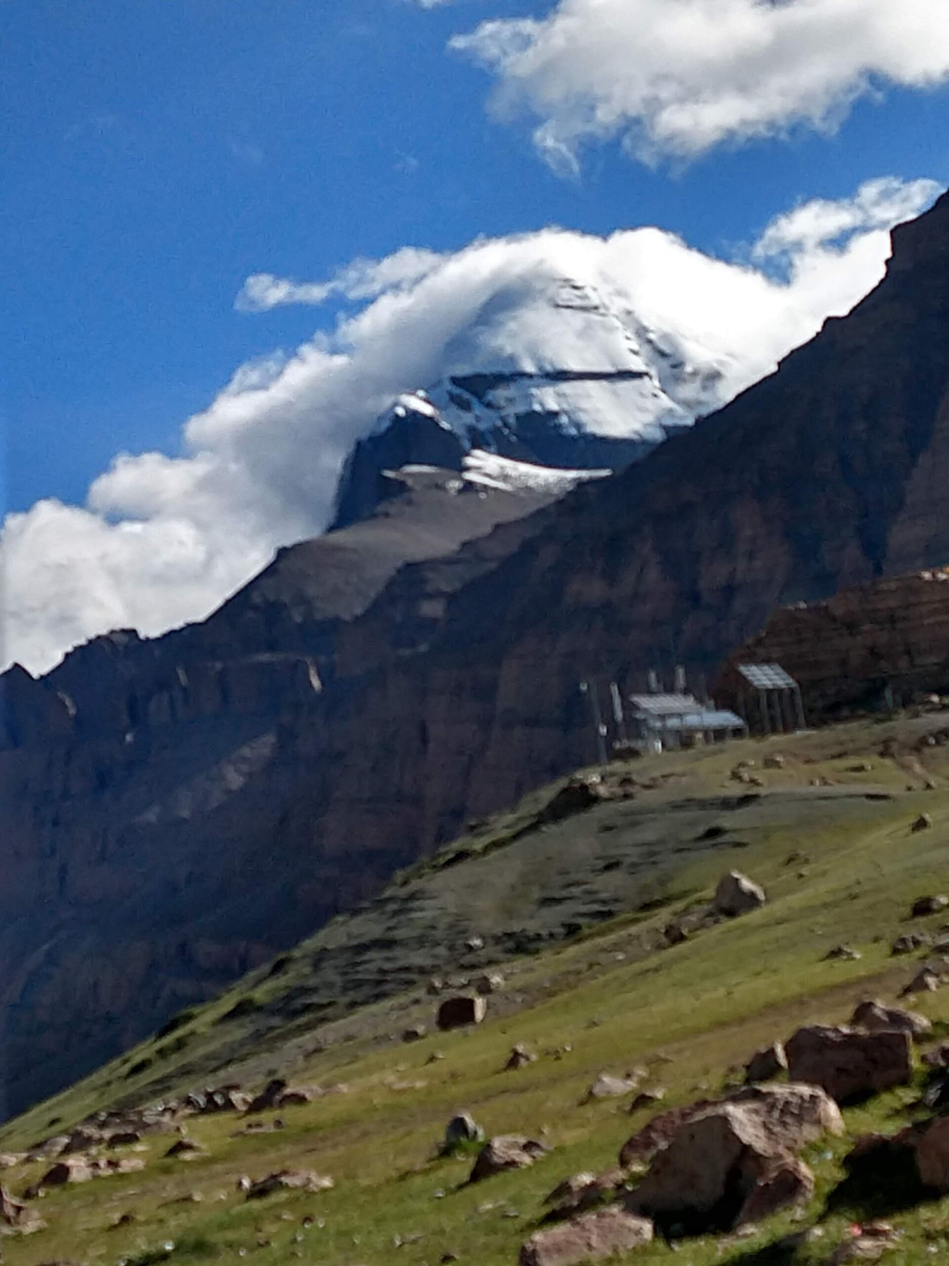 The snow-covered pyramid peak of Mount Kailash in Tibet under a blue sky