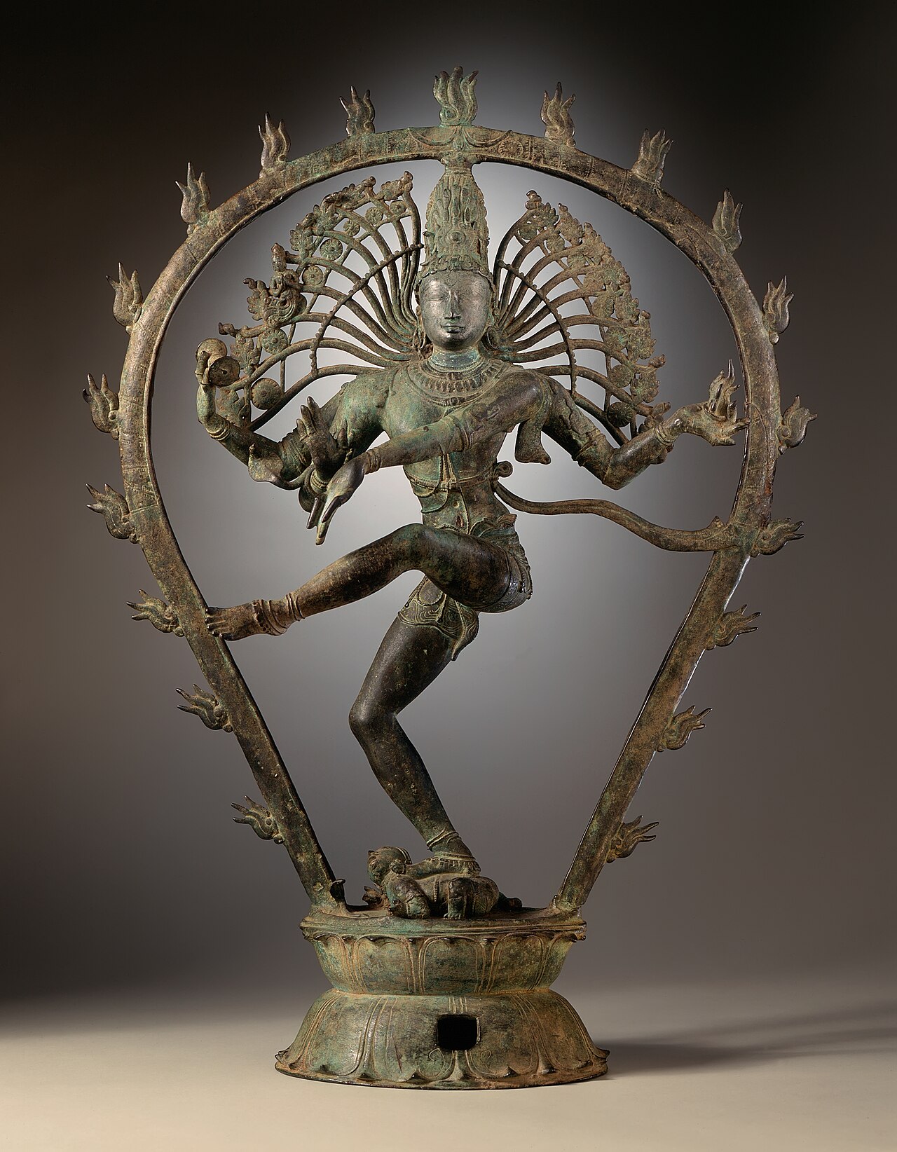 Chola-era bronze of Shiva Nataraja dancing within a ring of flames, one foot raised, the dwarf of ignorance beneath the other